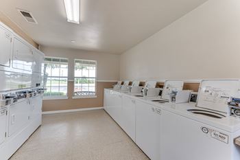 Community laundry room with multiple washers and dryers